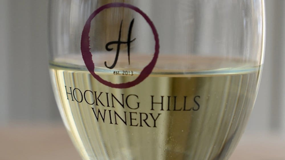 Close-up of a wine glass with Hocking Hills Winery logo