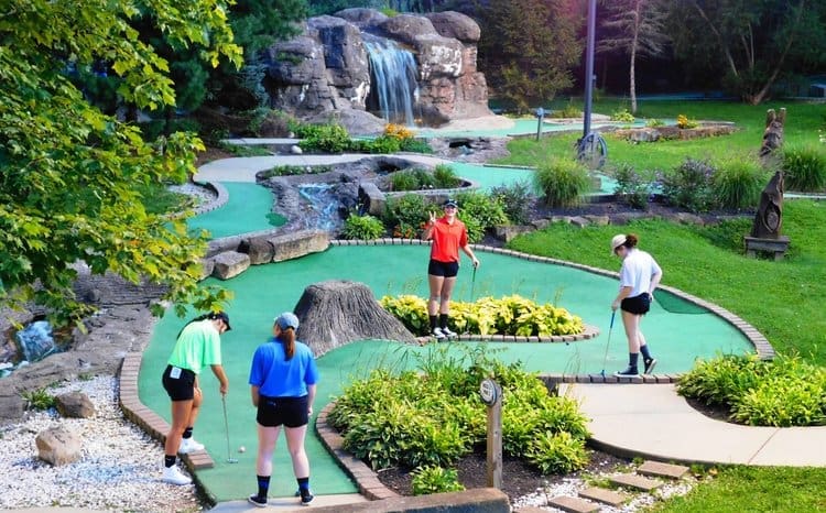 Families playing mini golf at Rempel’s Grove Adventure Golf
