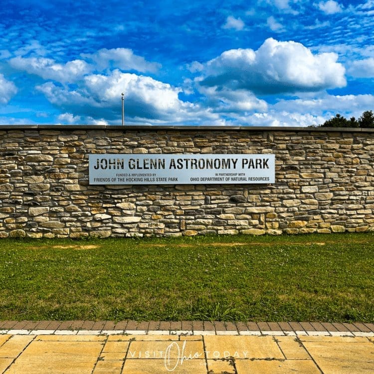 Sign for John Glenn Astronomy Park on a grassy lawn