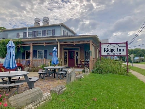 Outdoor view of The Ridge Inn with patio seating area