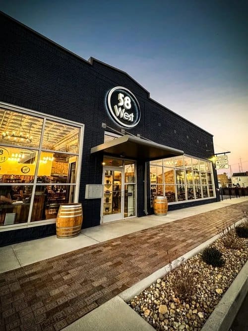 Exterior of 58 West restaurant with string lights and outdoor seating