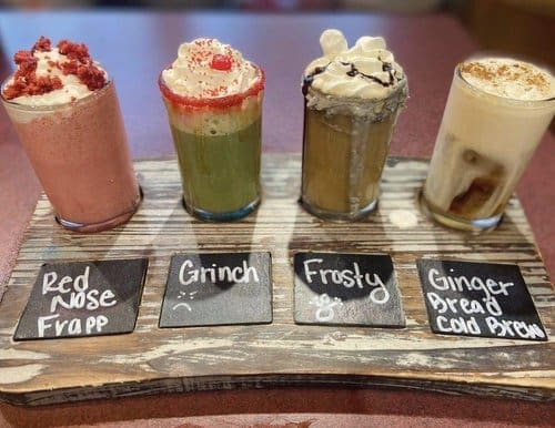 Coffee flight samples labeled with flavors at Oasis Coffee Shop