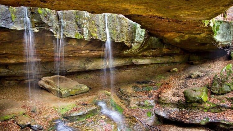 Natural rock bridge formation over a forest stream at Rockbridge State Nature Preserve