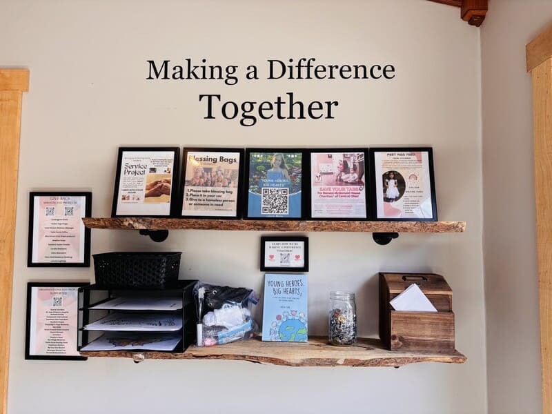 Giving Back Wall in the Woodland Lodge sunroom, sharing the causes each family's stay supports in Southeast Ohio